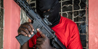 A G-9 federation gang member holds a gun