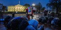 Protester pray in the rain outside the White House.