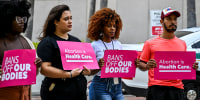 Members of Florida Planned Parenthood PAC Abortion rights activists hold signs that read "Bans   off our Bodies, " and "Abortion is Health Care"