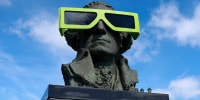 Eclipse glasses are worn by a statue of George Washington on April 7, 2024, in Houlton, Maine. 