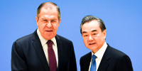 Russian Foreign Minister Sergei Lavrov, left, shakes hands with Chinese State Councilor and Foreign Minister Wang Yi.