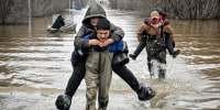 Rescuers evacuate residents from the flooded part of the southern tip of the Ural Mountains, Russia.