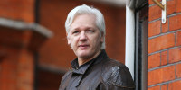 Assange speaks to the media from the balcony