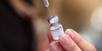 A nurse prepares doses of the Pfizer vaccine