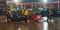 Swiftwater Rescue Paramedics rescue a driver trapped in a vehicle in Pittsburgh on April 12, 2024.