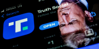 This photo illustration shows an image of former President Donald Trump reflected on a phone screen that is displaying the Truth Social app