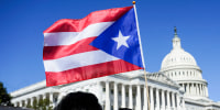 A woman waves the flag of Puerto Rico
