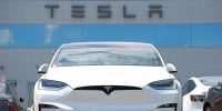 A Tesla Model X sits at dealership  in Englewood, Colo., in 2023. 