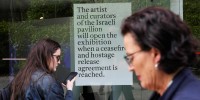 The sign announces that the artist and curators representing Israel at this year's Venice Biennale won't open the Israeli pavilion until there is a cease-fire in Gaza and an agreement to release hostages taken Oct. 7. 