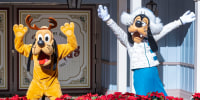 Cast members dressed as Pluto and Goofy at Disneyland, in Anaheim, Calif.
