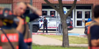 Police at the scene of a shooting at Bowie High School in Arlington, Texas.