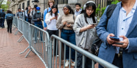 Columbia University students and personnel wait in line