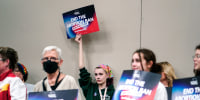 A supporter holds up a sign saying "End the Abortion Ban"