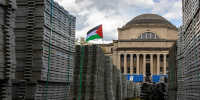 A Palestinian flag flies over supplies set up for Columbia's upcoming commencement ceremony.