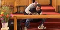 Bernard Junior Polite pinned down by a deacon from Dwelling Place Church. 