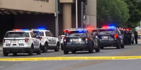 Police cars and police tape surround the Albuquerque Convention Center