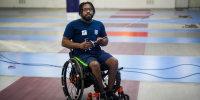 Paralympian fencer Vanderson Chaves poses for a photo in the gym where he trains