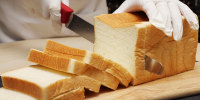 A loaf of white bread is sliced in Japan