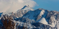 Clouds over snowy Lone Peak in the Wasatch Mountain Range by Salt Lake City, Utah.