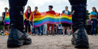 People wave gay rights' movement rainbow flags during the gay pride rally