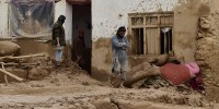 Afghan men clear debris and mud from a damaged house following a flash flood after a heavy rainfall in Laqiha village of Baghlan-i-Markazi district in Baghlan province on May 11, 2024. At least 62 people, mainly women and children, were killed on May 10 in flash flooding that ripped through Afghanistan's Baghlan province, in the north of the country, a local official told AFP.