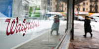 A Walgreens signage is seen on a storefront window.