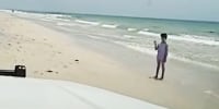 A sheiff's deputy approaches a lost girl on Indian Rocks Beach in Florida.