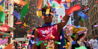 A dancer throws confetti during the NYC Pride March