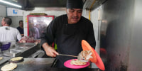 Arturo Rivera Martínez prepares an order of tacos 
