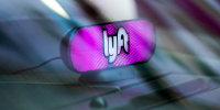 A Lyft Inc. light sits on the dashboard of a vehicle