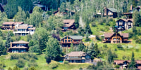 Houses dot a hillside in Steamboat Springs, Colo.