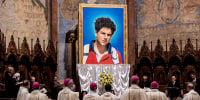 A tapestry featuring a portrait of Carlo Acutis hangs at the St. Francis Basilica during his beatification ceremony on Oct. 10, 2020 in Assisi, Italy. 