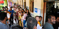 People queue up at a polling booth