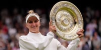 Czech Republic's Marketa Vondrousova holds the trophy after beating Tunisia's Ons Jabeur to win the final of the women's singles at Wimbledon
