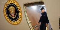 Image: President Joe Biden walks down the steps of Air Force One in Delaware.