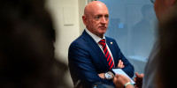 Mark Kelly speaks with reporters while waiting to catch the Senate subway to the Hart Senate Office Building from the U.S. Capitol