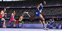 Grant Holloway crosses the finish line in the men's 110m hurdles at the Paris 2024 Olympic Games at Stade de France in Saint-Denis, north of Paris, on August 4, 2024. 