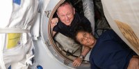 NASA’s Boeing Crew Flight Test astronauts Butch Wilmore and Suni Williams inside the vestibule between the forward port on the International Space Station’s Harmony module and the Starliner spacecraft.