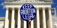 An protester holds a sign that reads, "Keep Abortion Legal"