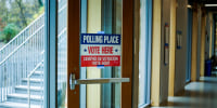 A door with a 'polling place' sign.