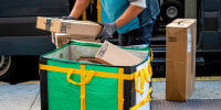 A worker delivers Amazon packages.