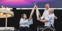 British Paralympians Helene Raynsford and Gregor Ewan light the Paralympic Flame in Stoke Mandeville, England.