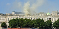 Viewed from Waterloo Bridge, smoke is seen rising into the sky from a fire located in the roof of Somerset House beside the River Thames in London on August 17, 2024. Around 100 firefighters tackled a large blaze.