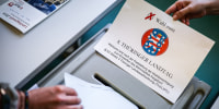 A ballot paper is placed into a ballot box