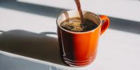 Coffee pouring in mug. 