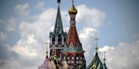 Kremlin's Spasskaya tower and St. Basil's cathedral in downtown Moscow 