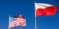 Polish and U.S. national flags fly