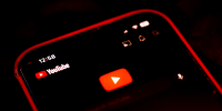 The logo for YouTube application arranged on a smartphone