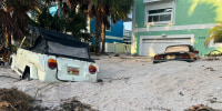 Cars are seen buried in sand after Hurricane Helene made landfall in Treasure Island, Florida.