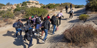 Migrants walking up a hill